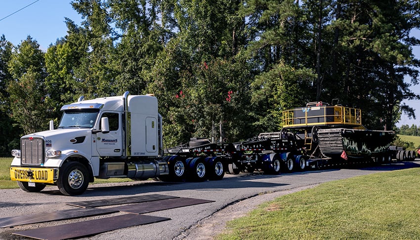 2 - Asset-Based Carrier - hauling large construction equipment on a flatbed dtruck
