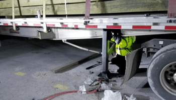 Comprehensive Road Service for Commercial & Heavy-Duty Trucks - photo of technician repairing a semi truck on the highway